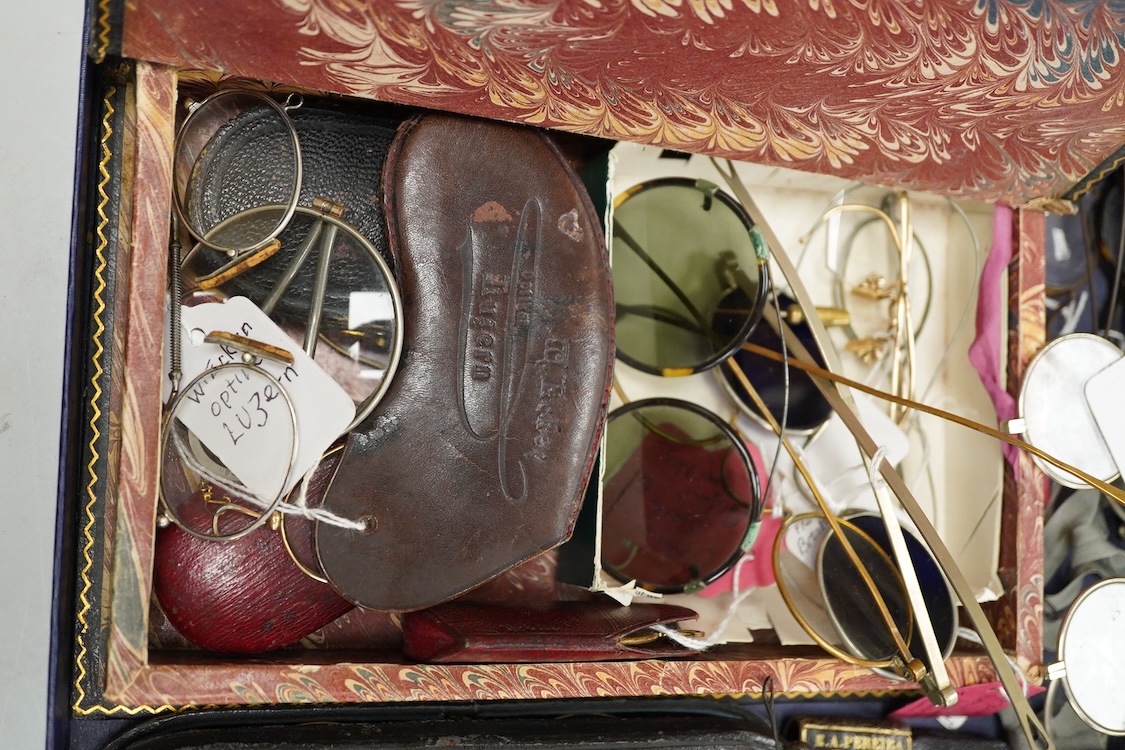 A collection of 18th-20th century steel, nickel, tortoiseshell, brass or faux tortoiseshell spectacles, some cased, five 19th century pince nez, some cased and a quizzing glass etc.